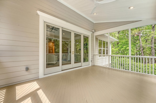 unfurnished sunroom featuring a ceiling fan