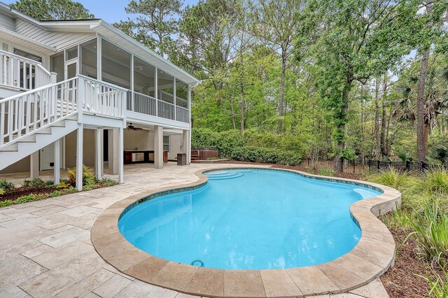view of pool with a sunroom, stairway, a patio area, fence, and a fenced in pool