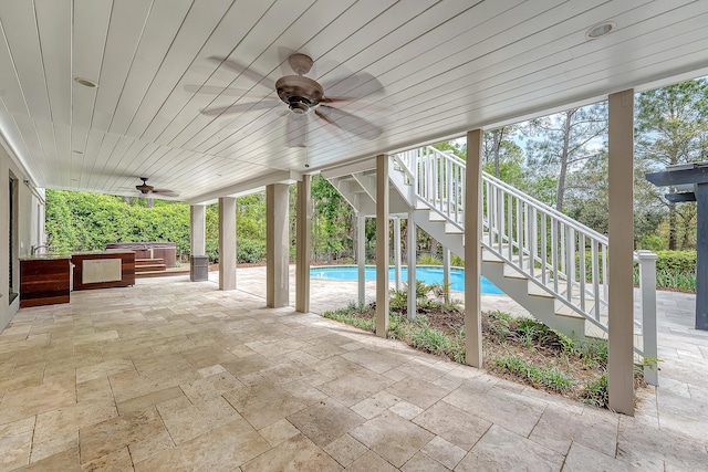 view of patio / terrace featuring an outdoor pool, a ceiling fan, and stairs