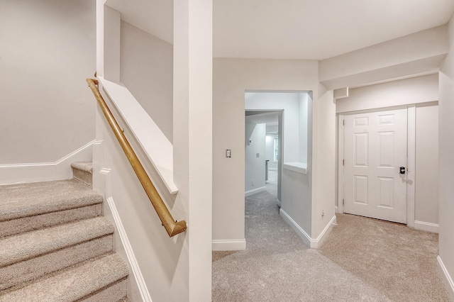 stairs with baseboards and carpet