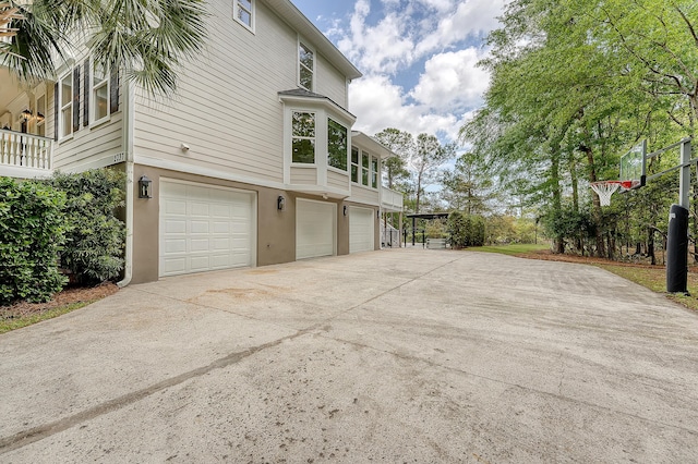 view of home's exterior featuring a garage, stucco siding, and concrete driveway