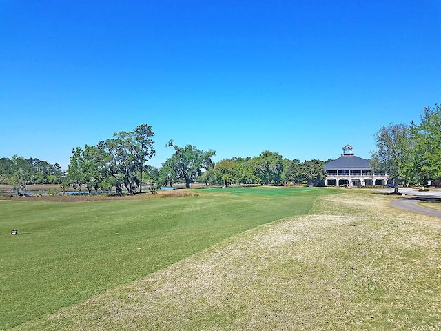 view of property's community featuring a yard and golf course view