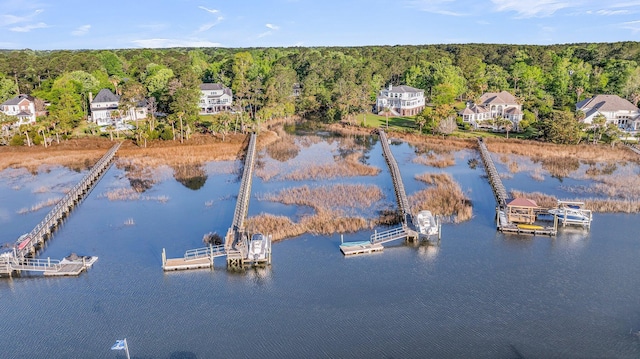 aerial view featuring a wooded view and a water view