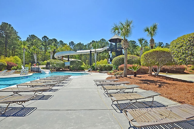 pool featuring a patio area and a water slide