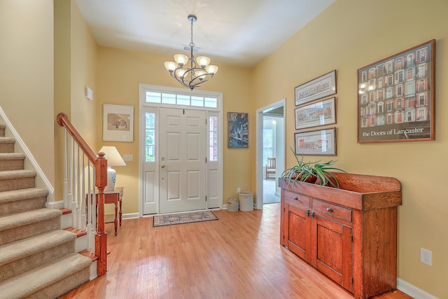 405 Decatur Dr, Summerville, SC 29486 - foyer entrance featuring baseboards, a notable chandelier, light wood finished floors, and stairway