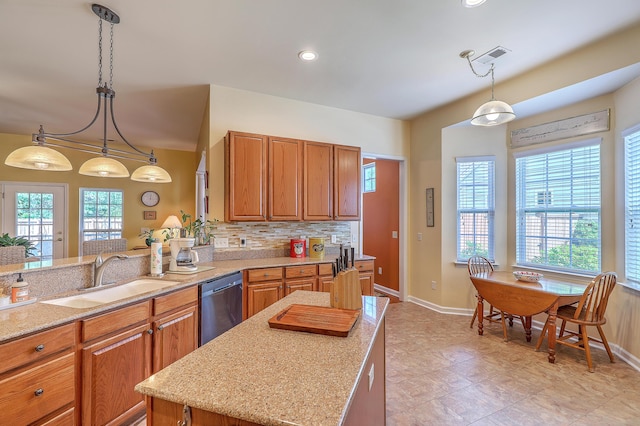 405 Decatur Dr, Summerville, SC 29486 - kitchen with baseboards, brown cabinetry, a sink, and dishwasher