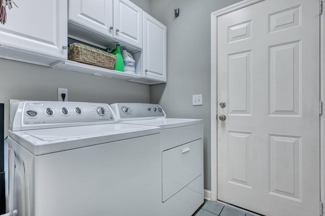 laundry room featuring cabinet space, washer and clothes dryer, and light tile patterned floors