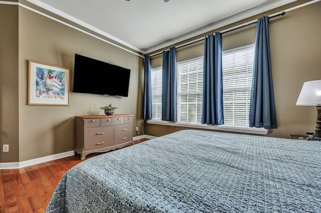 bedroom featuring baseboards and wood finished floors