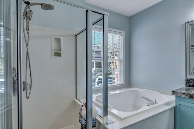 bathroom with plenty of natural light, a shower, a bath, and vanity