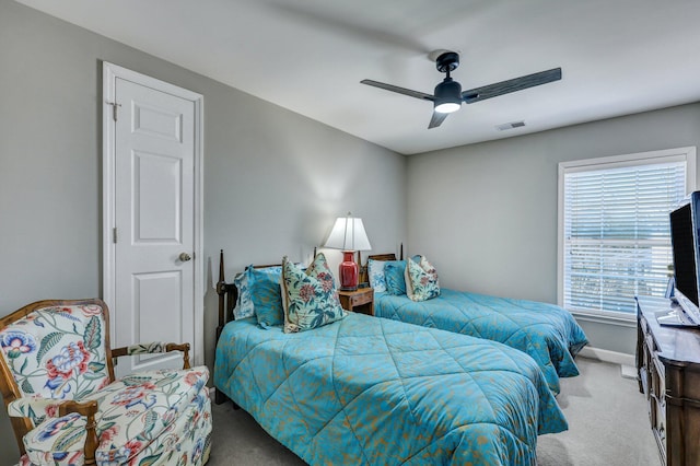 carpeted bedroom featuring ceiling fan, visible vents, and baseboards