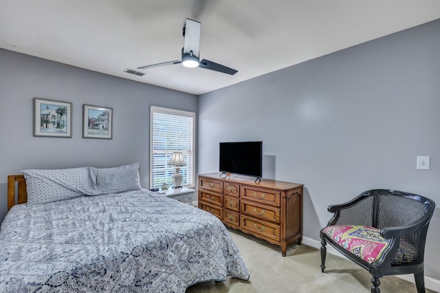 bedroom with baseboards, visible vents, ceiling fan, and light colored carpet