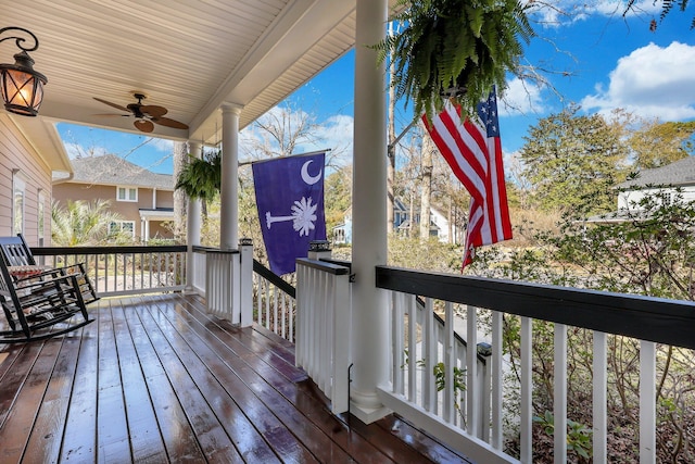 wooden terrace with a ceiling fan