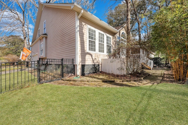 view of side of property with fence and a lawn