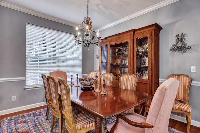 dining area with baseboards, a notable chandelier, ornamental molding, and wood finished floors