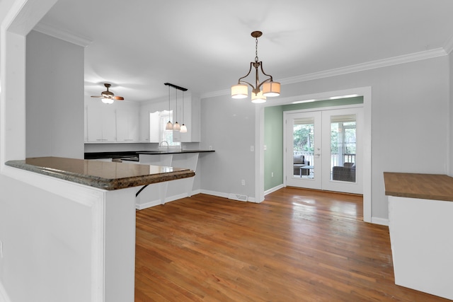 kitchen with dark countertops and ornamental molding