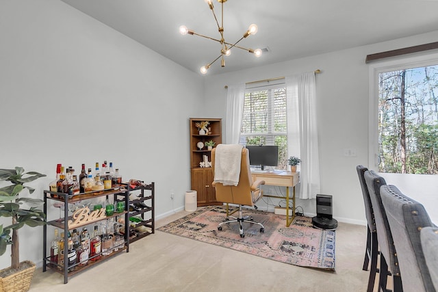 office featuring lofted ceiling, a chandelier, and carpet