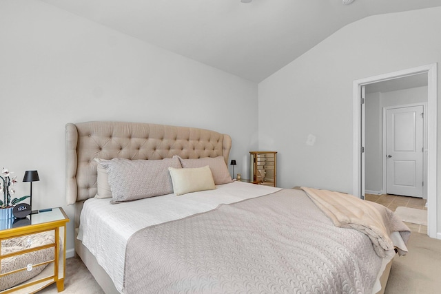 bedroom featuring lofted ceiling and light carpet