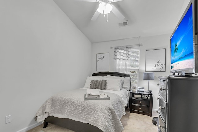 bedroom featuring light carpet, vaulted ceiling, and ceiling fan