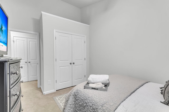 bedroom featuring a closet and light carpet