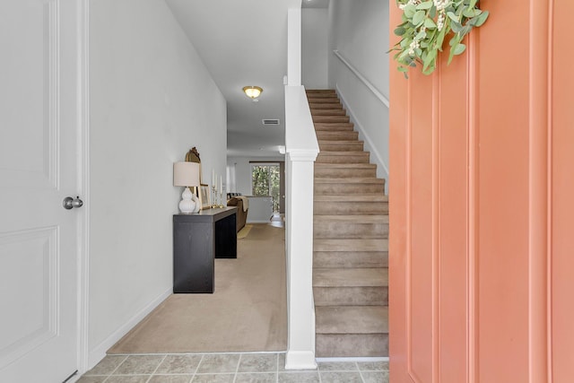 staircase featuring carpet flooring