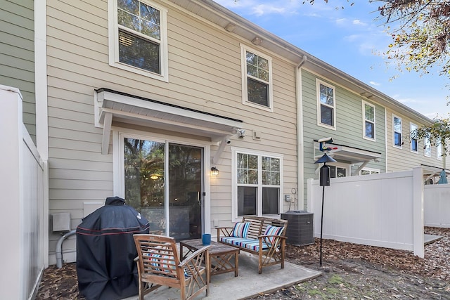 rear view of property featuring a patio and central AC unit