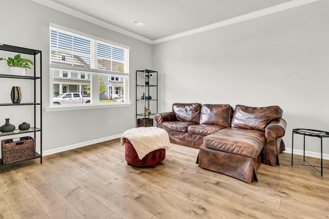 living room featuring crown molding and light hardwood / wood-style flooring