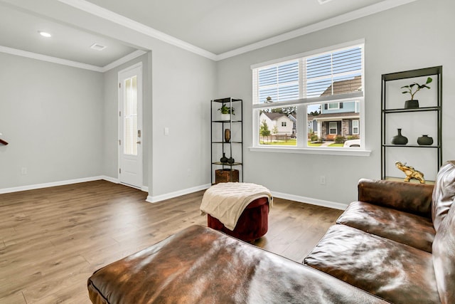 living room with ornamental molding and hardwood / wood-style flooring