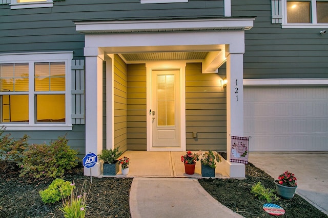 doorway to property with a garage