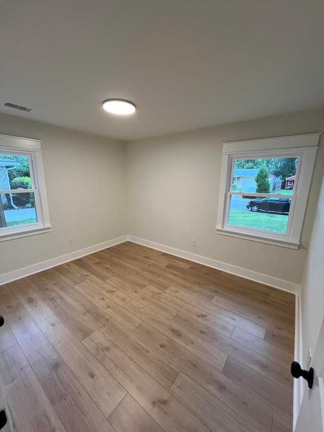 spare room with light wood-type flooring