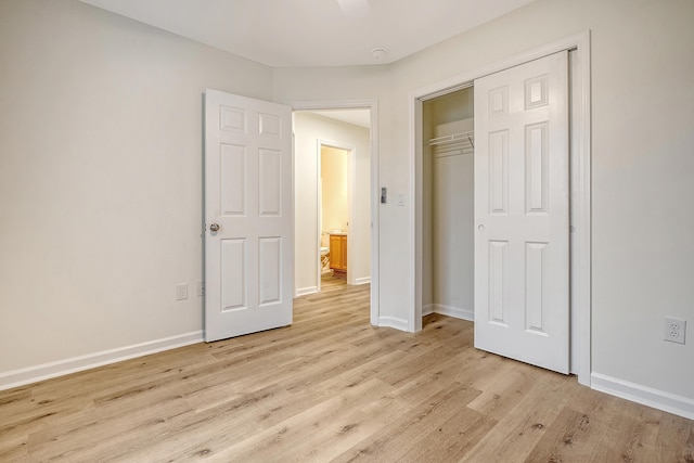 unfurnished bedroom with light wood finished floors, a closet, and baseboards