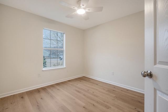 unfurnished room with ceiling fan, light wood-type flooring, and baseboards