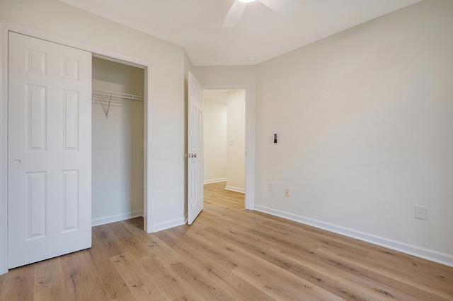 unfurnished bedroom featuring light wood finished floors, a closet, a ceiling fan, and baseboards