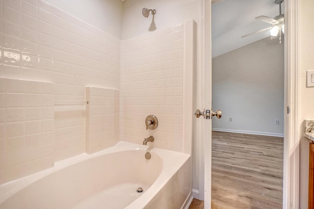 bathroom featuring shower / washtub combination, ceiling fan, vanity, wood finished floors, and baseboards