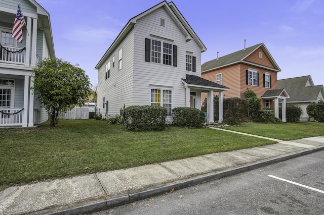 traditional-style home with fence and a front yard