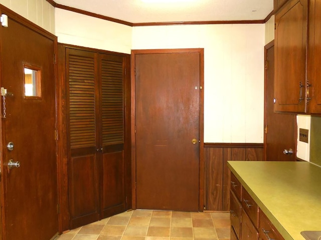 kitchen with crown molding and wooden walls