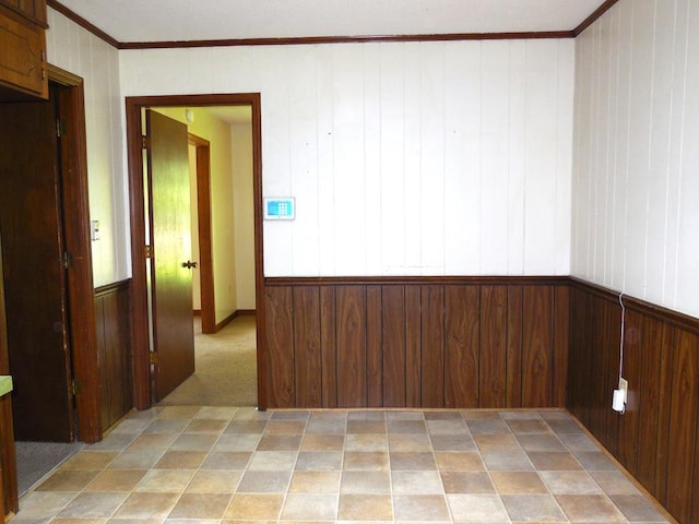 empty room with wood walls and crown molding