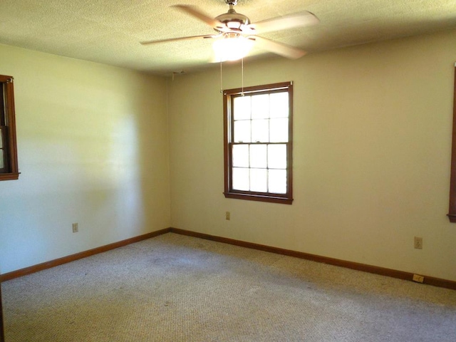 unfurnished room with ceiling fan, carpet, and a textured ceiling