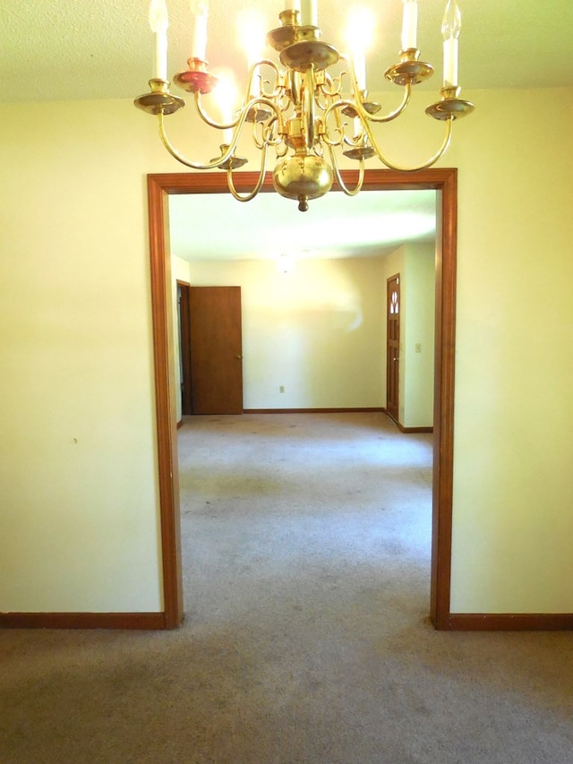 carpeted empty room with a textured ceiling