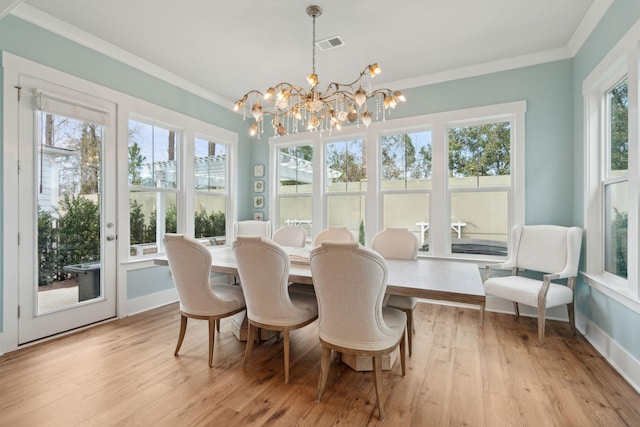 sunroom / solarium featuring a chandelier