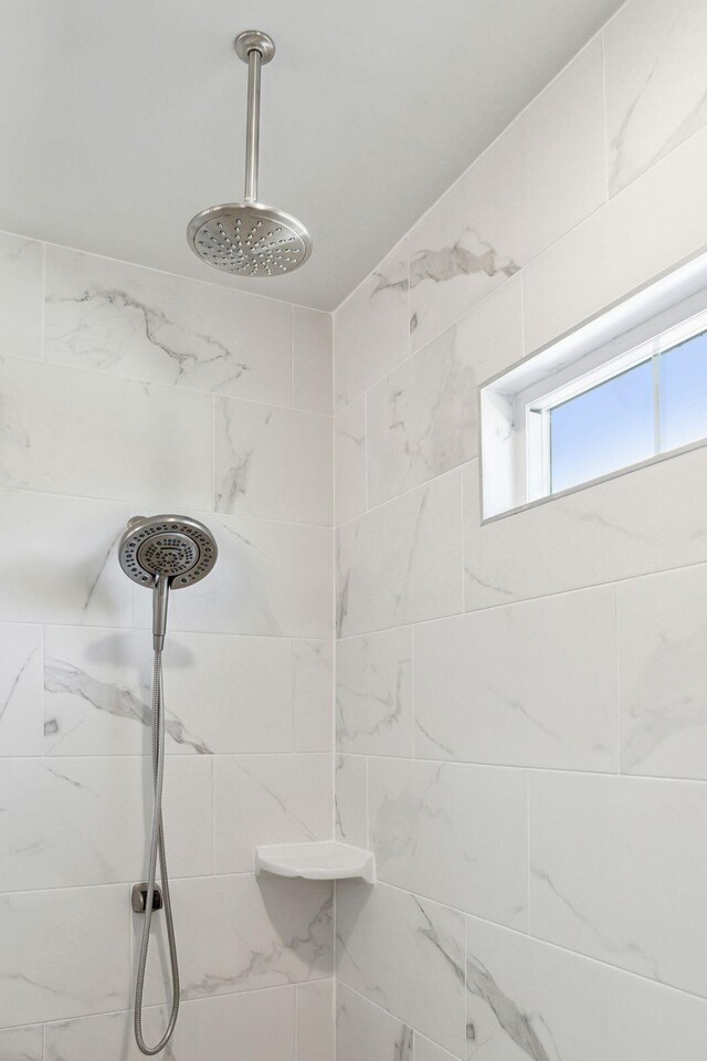 bathroom with a tile shower