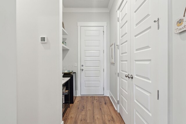 interior space featuring crown molding and light wood-type flooring