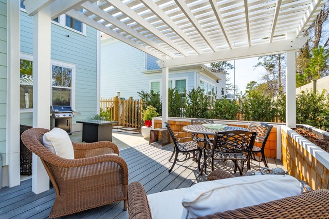 wooden deck with a pergola and grilling area