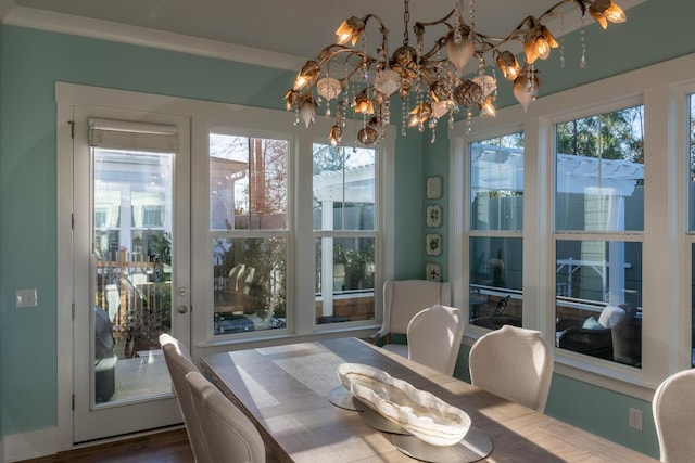 dining room with a notable chandelier, hardwood / wood-style flooring, and a wealth of natural light