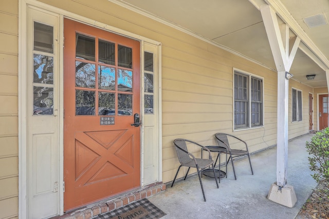 doorway to property featuring covered porch