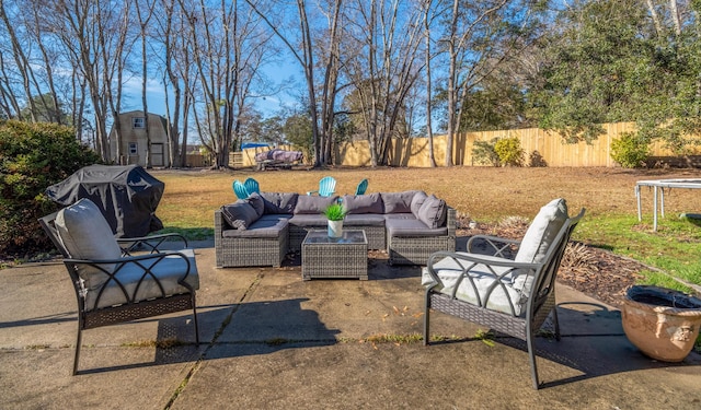 view of patio featuring a trampoline, grilling area, outdoor lounge area, and a playground