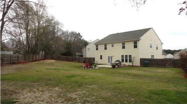 rear view of house with a yard