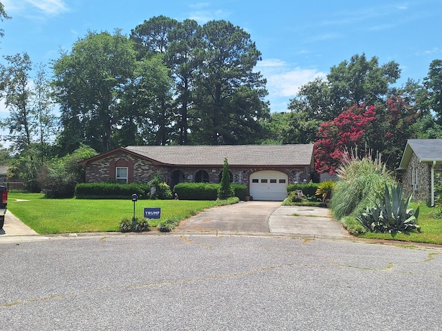 ranch-style house with a garage and a front lawn