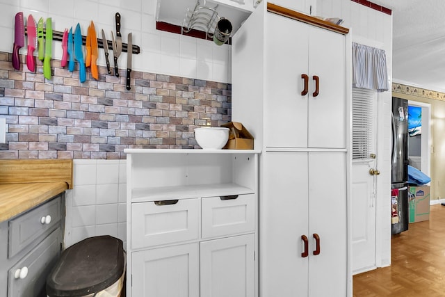 bathroom featuring tile walls, a textured ceiling, and parquet floors