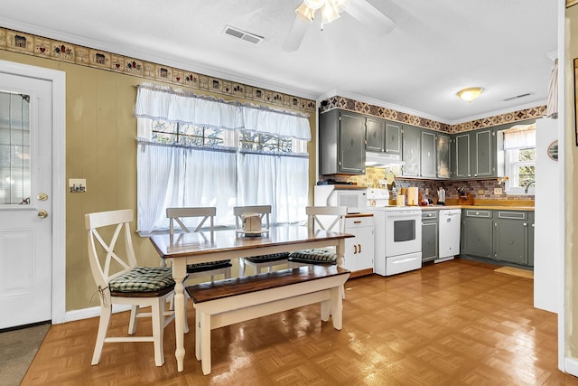 kitchen with ceiling fan, light parquet flooring, white appliances, gray cabinetry, and decorative backsplash