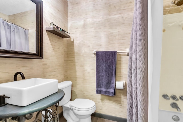 full bathroom with toilet, sink, and shower / bathtub combination with curtain